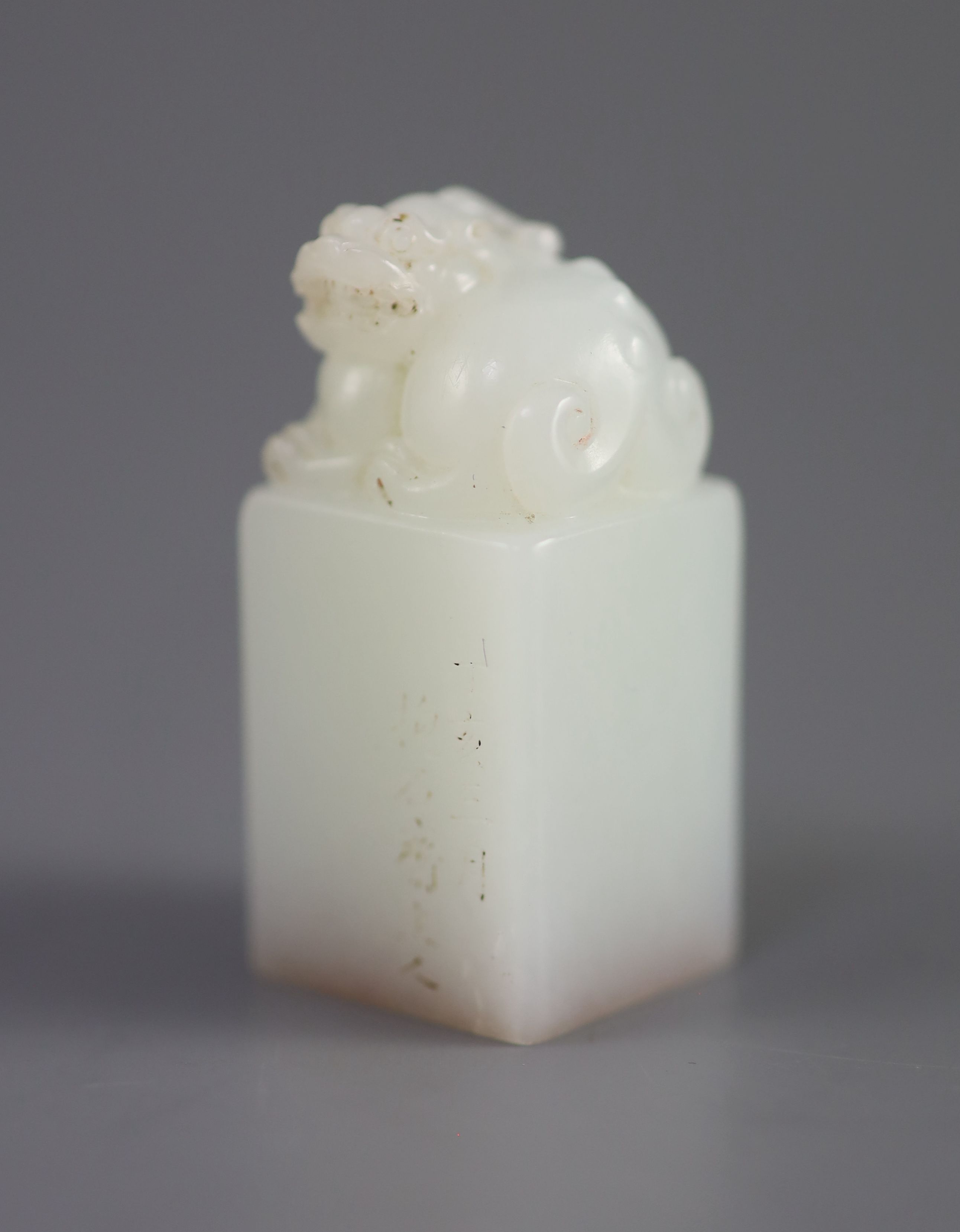 A Chinese inscribed white jade seal, 20th century, 4.3cm